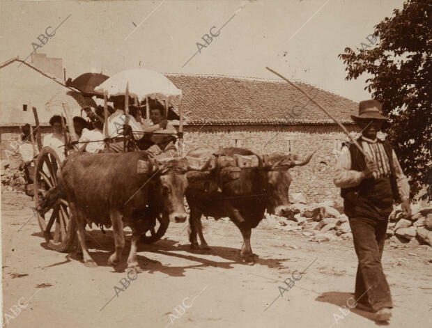 Excursionistas de camino al monte en un carro de bueyes