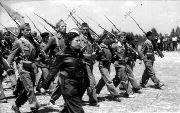 Una mujer comisaria política de las fuerzas del Comandante Líster desfilando con...