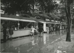 Lluvias durante la Feria del Libro de Madrid, la gente intenta pasar como puede...