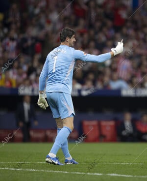 En la imagen, Courtois muestra al árbitro uno de los mecheros lanzados desde la...